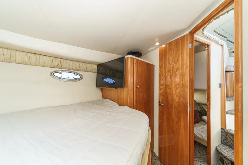 Slide: The Image of 2003 Meridian 341 Sedan interior cabin with bed, TV, and wooden doors. - 16