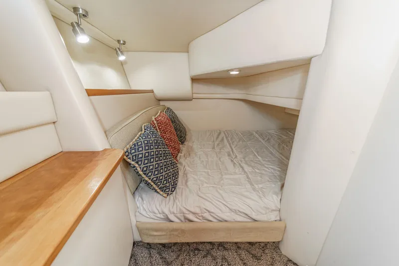 Slide: The Image of Cozy cabin interior of 2003 Meridian 341 Sedan with bed and decorative pillows. - 17