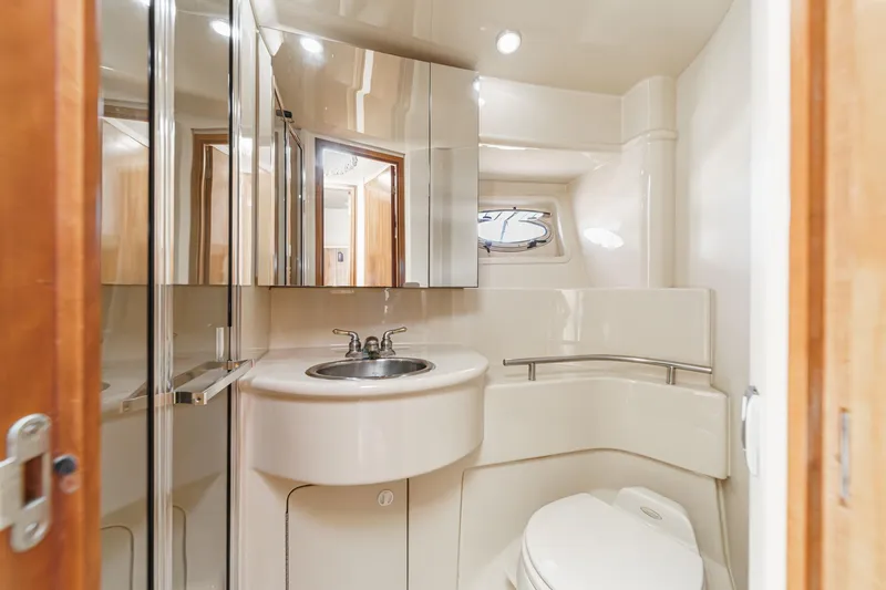 Slide: The Image of Luxurious bathroom in 2003 Meridian 341 Sedan yacht with modern fixtures and mirrors. - 18