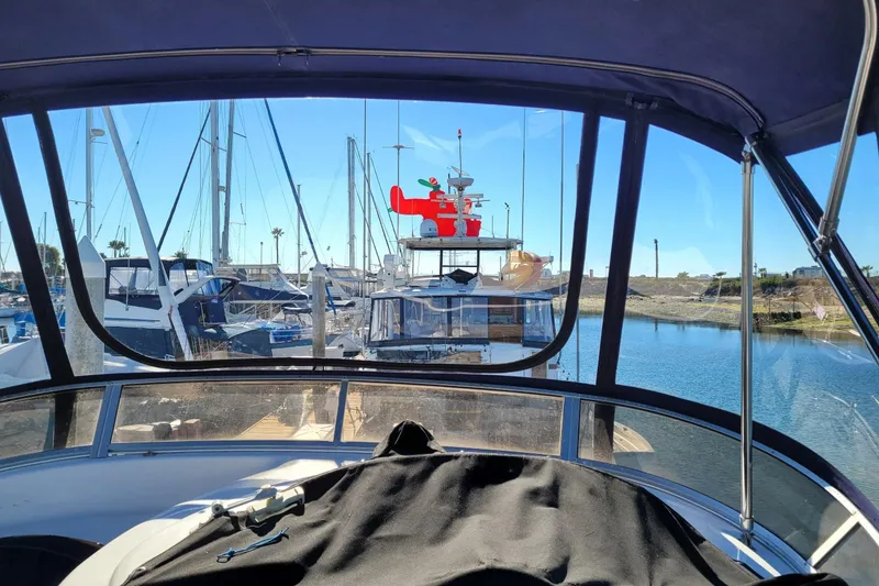 Slide: The Image of 2003 Meridian 341 Sedan in marina, view from cockpit, boats docked, clear sky. - 30