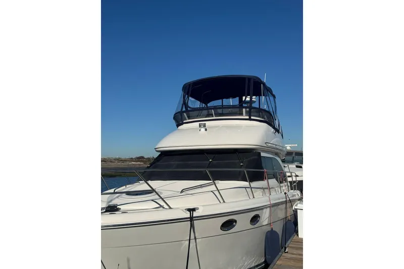 Slide: The Image of 2003 Meridian 341 Sedan yacht docked under clear blue sky. - 32