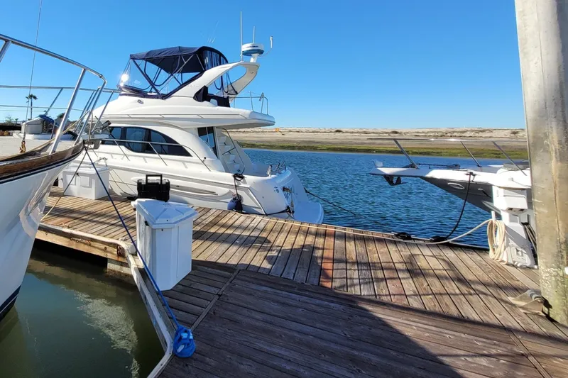 Slide: The Image of 2003 Meridian 341 Sedan yacht docked at a marina under clear blue skies. - 33