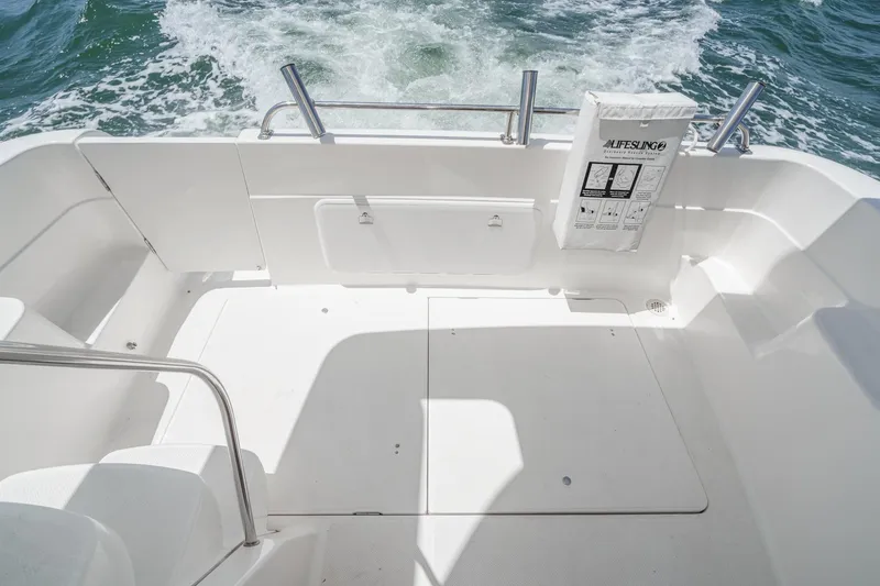 Slide: The Image of 2003 Meridian 341 Sedan boat deck with safety equipment, cruising on water. - 4