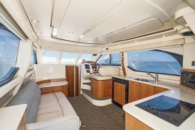 Slide: The Image of Interior of 2003 Meridian 341 Sedan yacht with modern kitchen and seating area. - 6