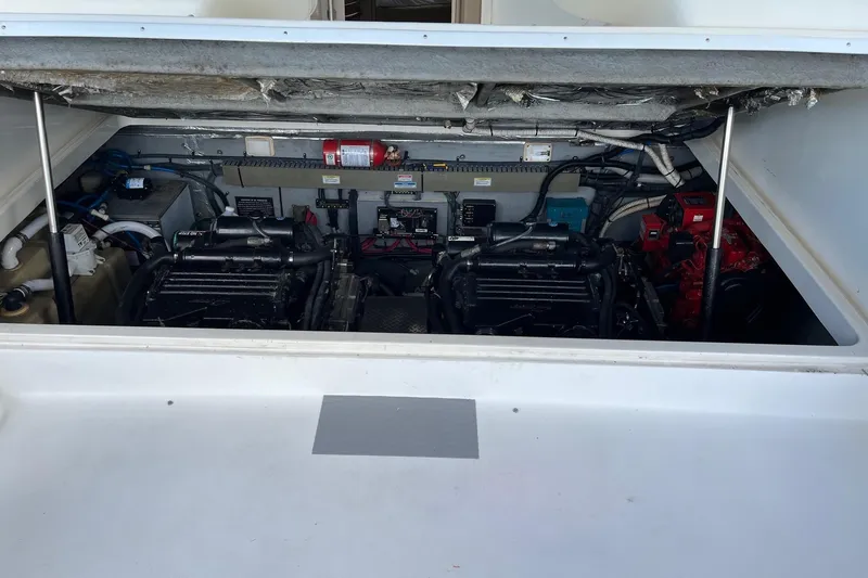 Slide: The Image of Engine compartment of 2001 Sea Ray 340 Amberjack boat, showcasing dual engines and equipment. - 14