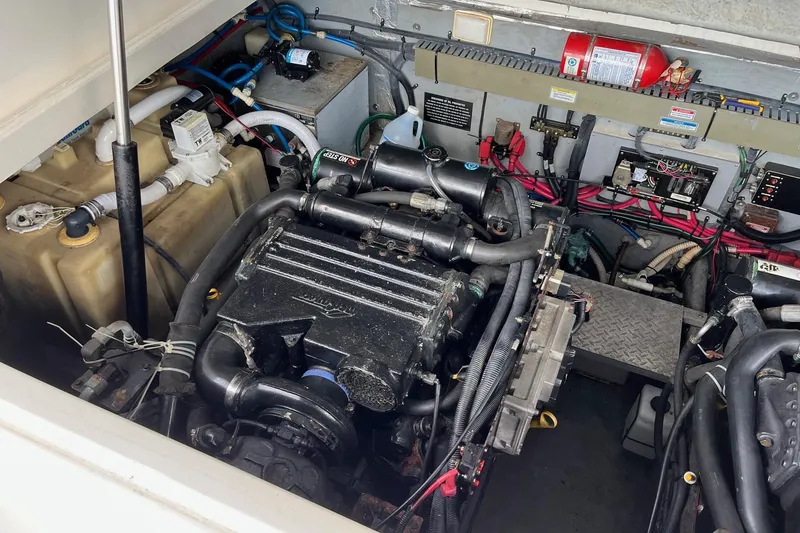 Slide: The Image of Engine compartment of a 2001 Sea Ray 340 Amberjack boat, showcasing mechanical components. - 15