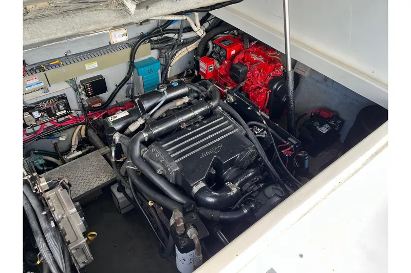 Slide: The Image of Engine compartment of a 2001 Sea Ray 340 Amberjack, showcasing mechanical components and wiring. - 16