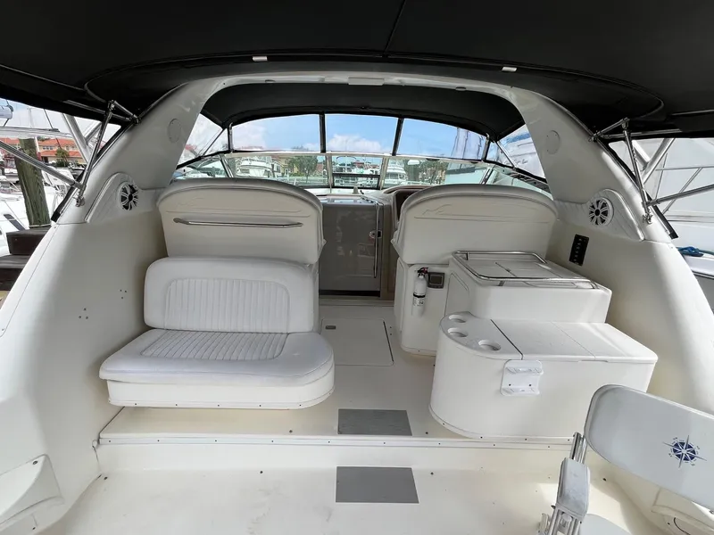 Slide: The Image of 2001 Sea Ray 340 Amberjack boat interior with white seating and helm station. - 6