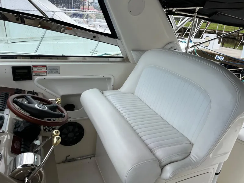 Slide: The Image of 2001 Sea Ray 340 Amberjack helm with white seating and steering wheel. - 7