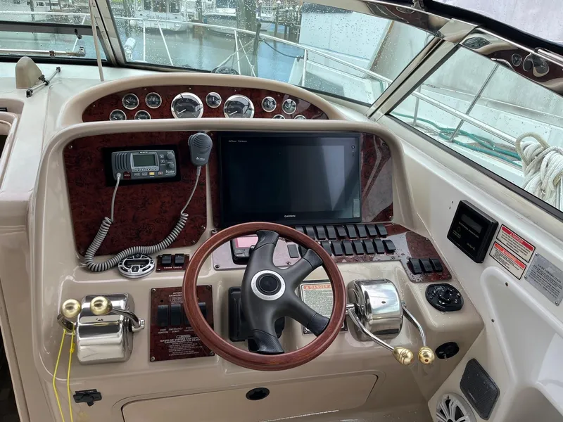 Slide: The Image of 2001 Sea Ray 340 Amberjack helm with steering wheel, gauges, and navigation equipment. - 8