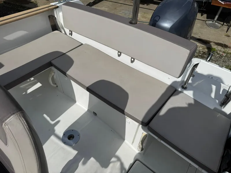 Slide: The Image of Jeanneau Cap Camarat 6.5 WA 2015 boat seating area with gray cushions. - 3