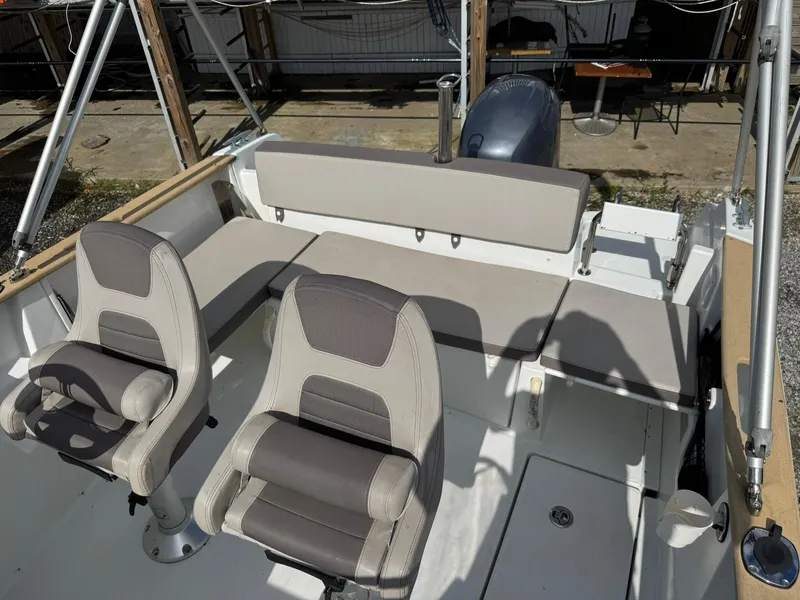 Slide: The Image of 2015 Jeanneau Cap Camarat 6.5 WA boat interior with seating and steering area. - 4
