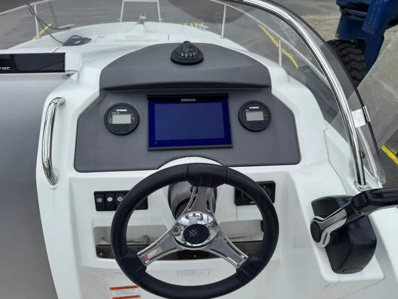 Slide: The Image of Steering console of a 2015 Jeanneau Cap Camarat 6.5 WA boat with navigation instruments. - 5