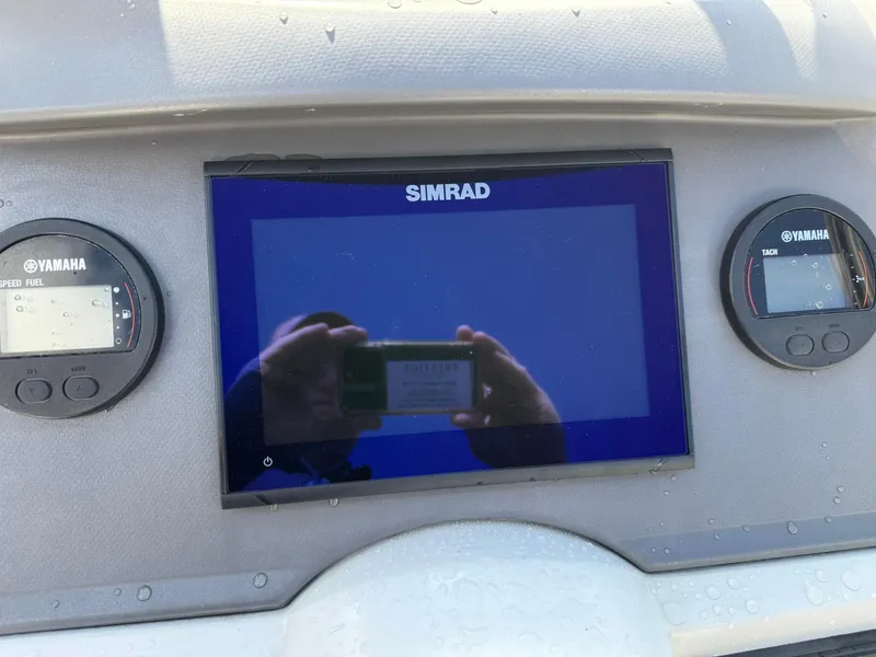 Slide: The Image of Dashboard of 2015 Jeanneau Cap Camarat 6.5 WA with Simrad and Yamaha displays. - 6