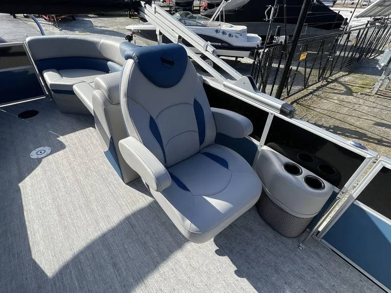 Slide: The Image of 2025 South Bay 224RSLE boat interior with plush seating and cup holders. - 15