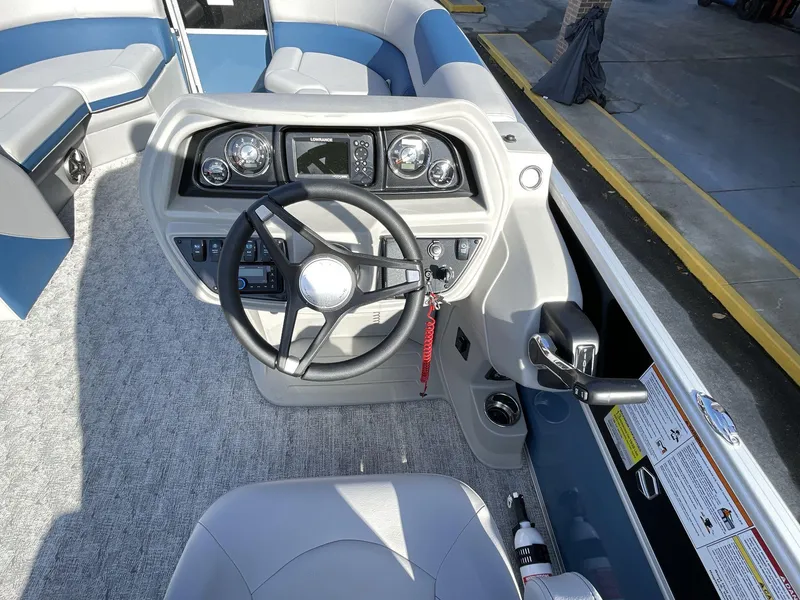Slide: The Image of 2025 South Bay 224RSLE boat dashboard with steering wheel and controls. - 18