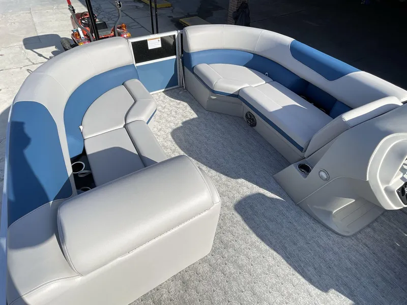 Slide: The Image of 2025 South Bay 224RSLE pontoon boat interior with gray and blue seating. - 21