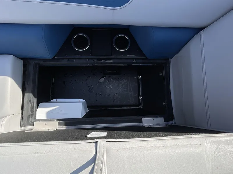 Slide: The Image of Interior storage compartment of 2025 South Bay 224RSLE boat with cup holders. - 22