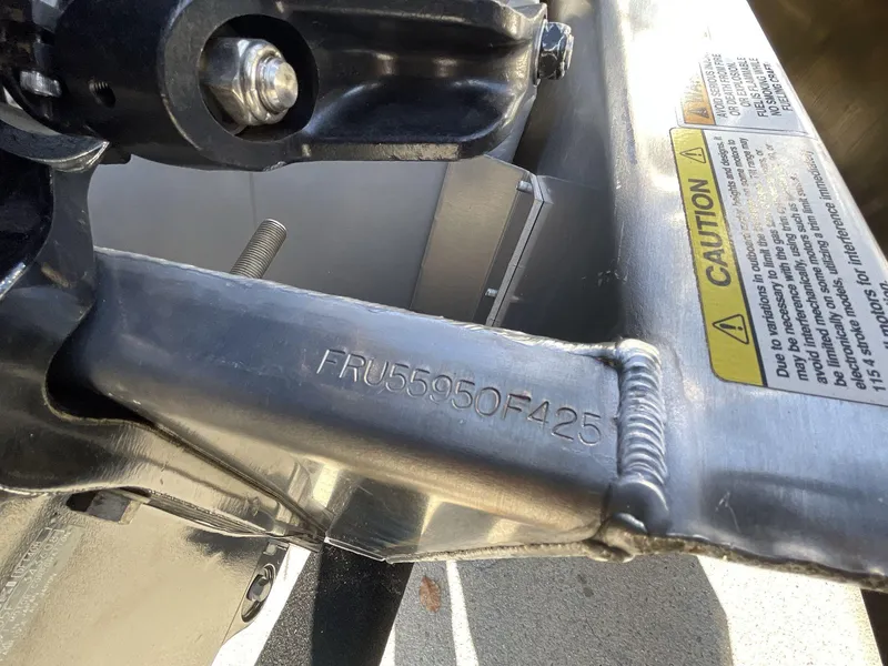 Slide: The Image of Close-up of South Bay 224RSLE 2025 boat component with caution label and serial number. - 23