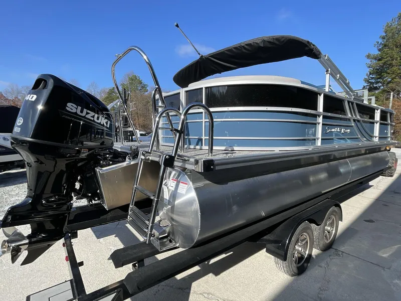 Slide: The Image of 2025 South Bay 224RSLE pontoon boat with Suzuki outboard motor on trailer. - 6