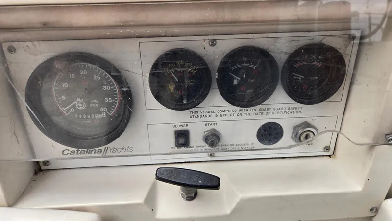 Slide: The Image of 1992 Catalina 30 Tall Rig yacht dashboard with gauges and safety compliance notice. - 10