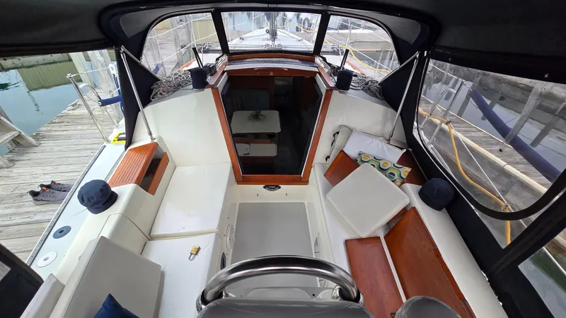 Slide: The Image of Interior view of a 1992 Catalina 30 Tall Rig sailboat, featuring seating and helm. - 12