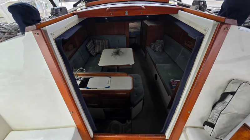 Slide: The Image of Interior view of a 1992 Catalina 30 Tall Rig sailboat, featuring a cozy seating area. - 13