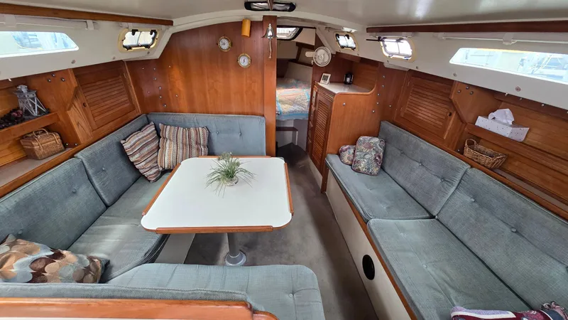Slide: The Image of Interior of 1992 Catalina 30 Tall Rig sailboat with cozy seating and wooden accents. - 15