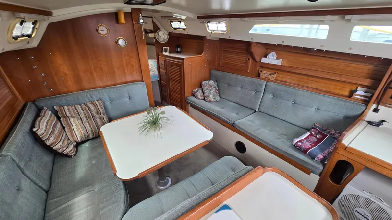 Slide: The Image of Interior of 1992 Catalina 30 Tall Rig sailboat with cozy seating and wooden accents. - 16