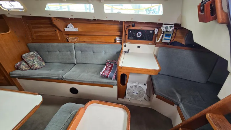 Slide: The Image of Interior of a 1992 Catalina 30 Tall Rig sailboat with seating and navigation area. - 17