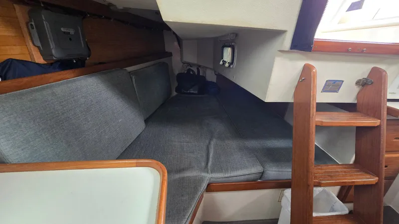 Slide: The Image of Interior of 1992 Catalina 30 Tall Rig sailboat with cozy seating and wooden ladder. - 18