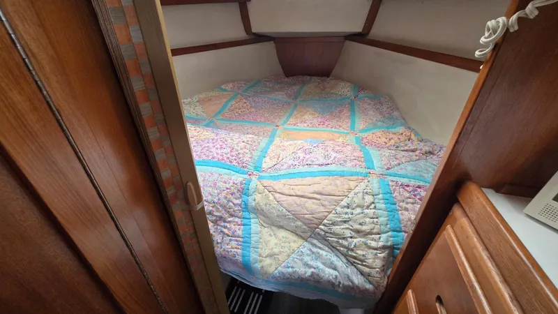 Slide: The Image of Cozy cabin interior of 1992 Catalina 30 Tall Rig with colorful quilted bedspread. - 20