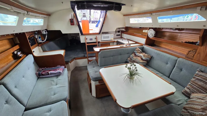 Slide: The Image of Interior of a 1992 Catalina 30 Tall Rig sailboat with cozy seating and a dining table. - 22