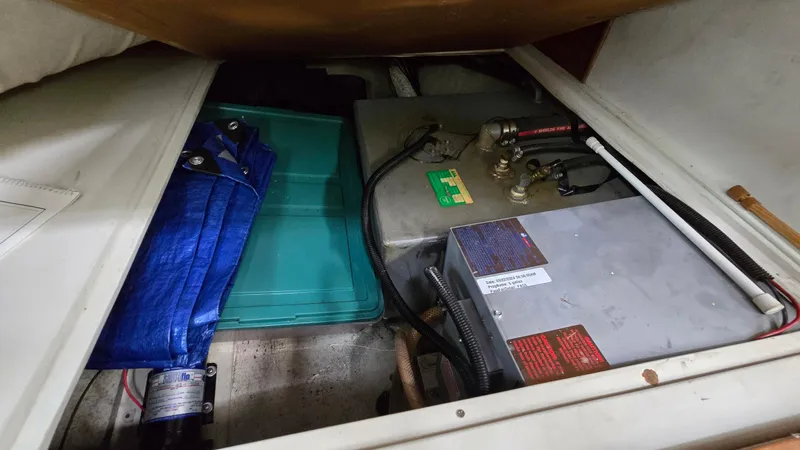 Slide: The Image of Storage compartment of a 1992 Catalina 30 Tall Rig sailboat with equipment and supplies. - 24