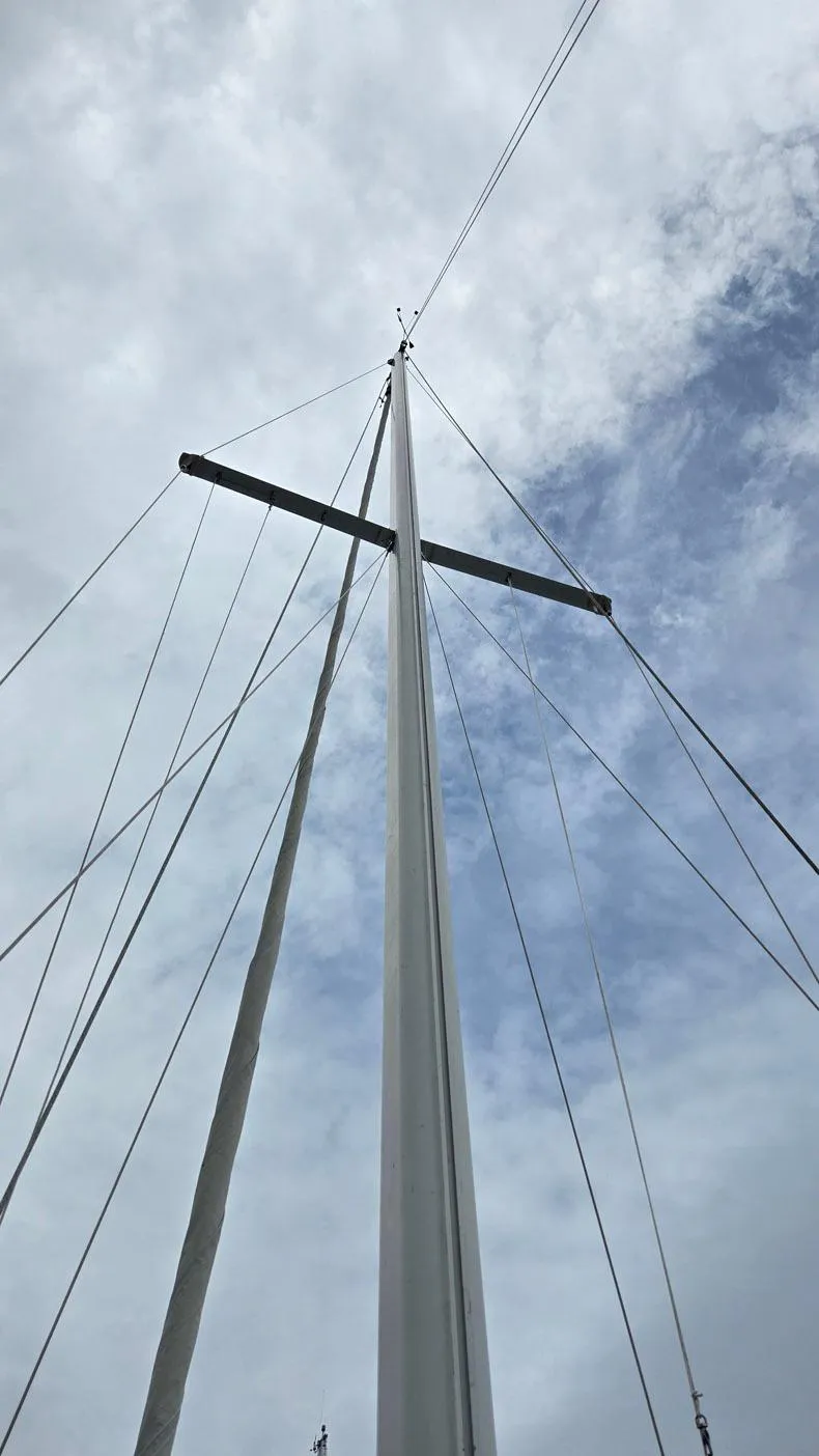 Slide: The Image of Tall mast of a 1992 Catalina 30 Tall Rig sailboat against a cloudy sky. - 31