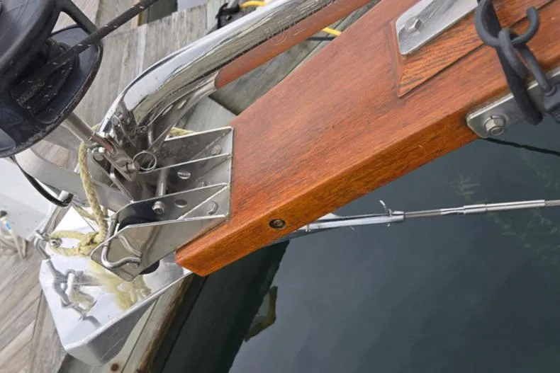 Slide: The Image of Close-up of a 1992 Catalina 30 Tall Rig's bow with wooden bowsprit and metal fittings. - 33
