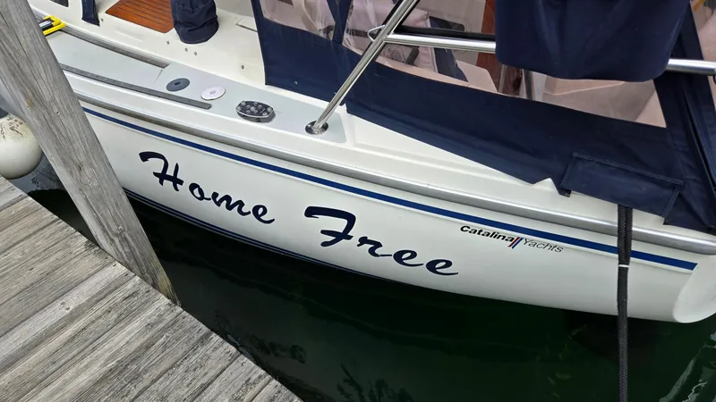Slide: The Image of 1992 Catalina 30 Tall Rig sailboat named "Home Free" docked at a marina. - 7