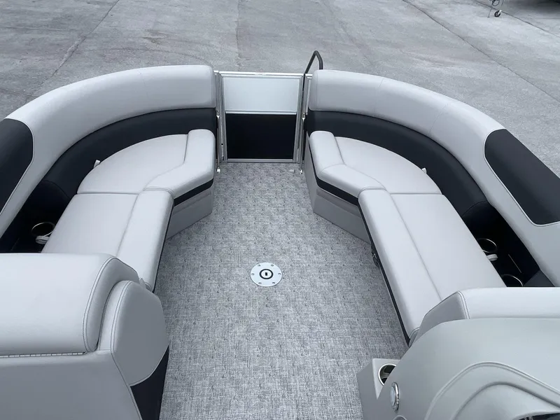 Slide: The Image of 2025 South Bay 224RSLE boat interior with gray seating and carpeted floor. - 14