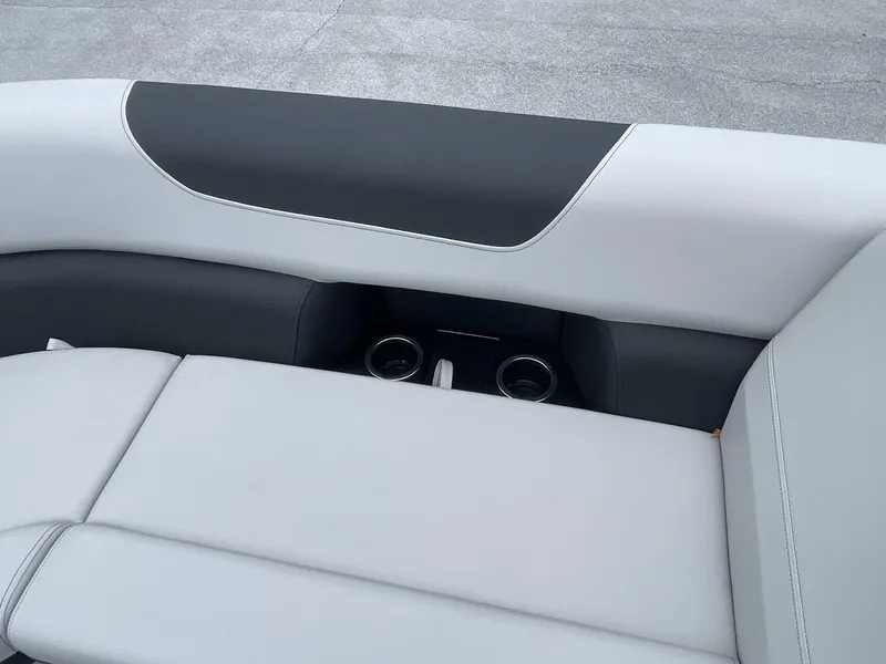 Slide: The Image of 2025 South Bay 224RSLE boat interior with gray seating and cup holders. - 15