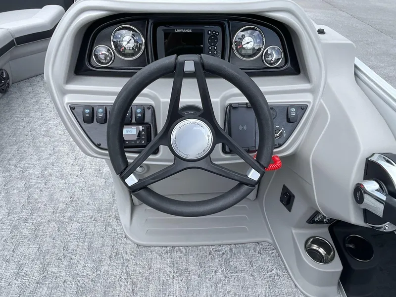 Slide: The Image of 2025 South Bay 224RSLE boat dashboard with steering wheel and control panel. - 17