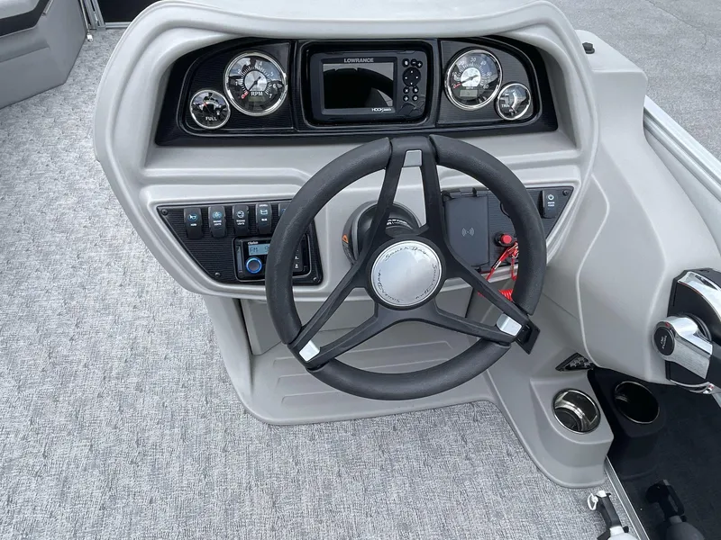 Slide: The Image of 2025 South Bay 224RSLE boat dashboard with steering wheel and control panel. - 19