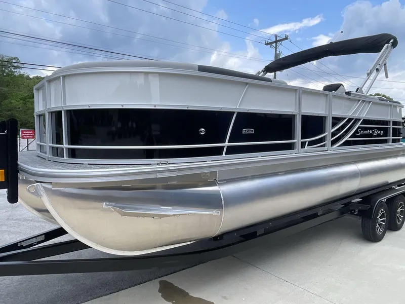 Slide: The Image of 2025 South Bay 224RSLE pontoon boat on trailer, featuring sleek design and modern amenities. - 2