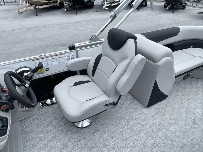 Slide: The Image of Captain's seat of 2025 South Bay 224RSLE pontoon boat, featuring modern design and controls. - 20