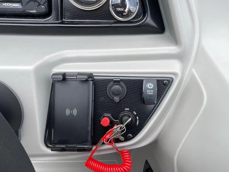 Slide: The Image of Control panel of 2025 South Bay 224RSLE boat with ignition and power switches. - 21