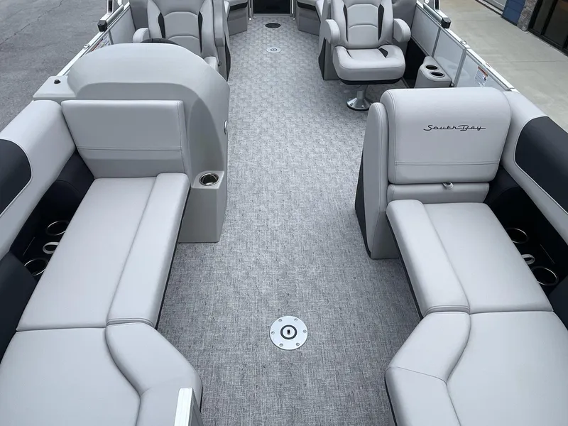 Slide: The Image of 2025 South Bay 224RSLE pontoon boat interior with gray seating and carpet. - 24