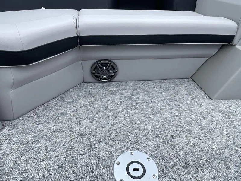 Slide: The Image of 2025 South Bay 224RSLE boat interior with gray seating and speaker detail. - 25