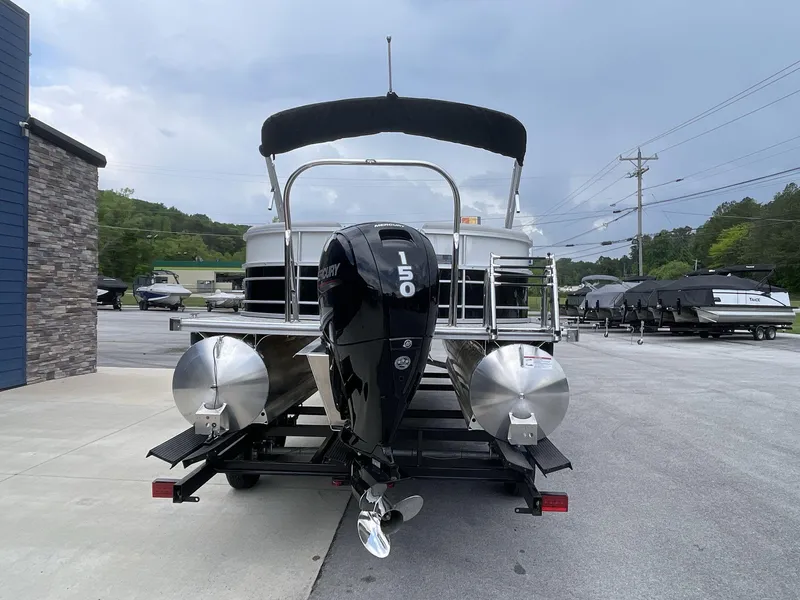 Slide: The Image of 2025 South Bay 224RSLE pontoon boat with Mercury 150 engine on trailer. - 5