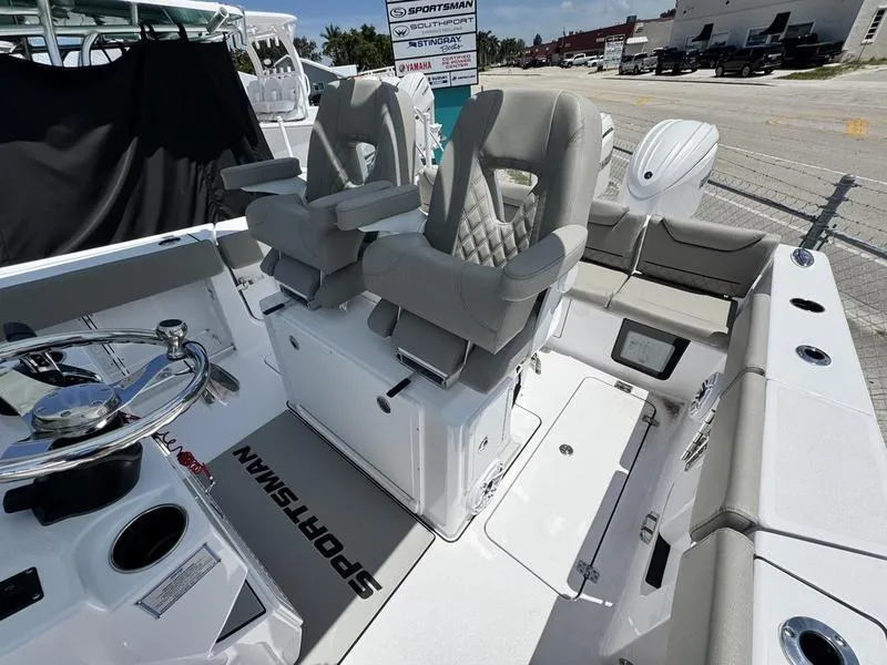 Slide: The Image of 2025 Sportsman Heritage 261 boat interior with dual captain's chairs and modern dashboard. - 14