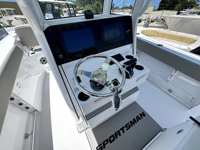 Slide: The Image of 2025 Sportsman Heritage 261 boat cockpit with modern steering and control panel. - 17
