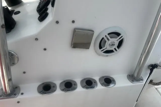Slide: The Image of 1999 Contender 27 Open Center Console boat dashboard with speaker and rod holders. - 11